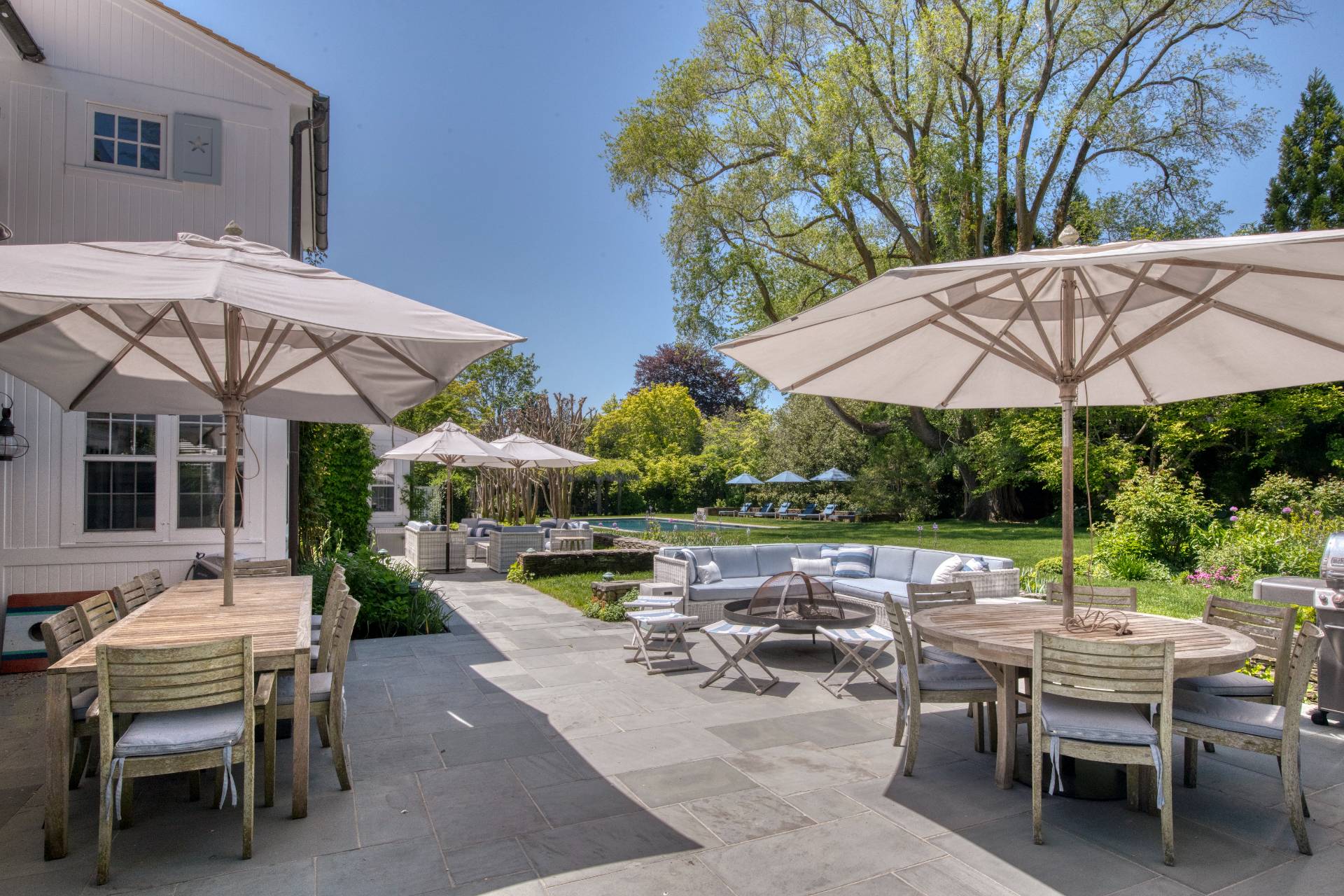 46 Westminster Road Water Mill, NY 11976 - Photo 20 of 28 a view of a patio with chairs and table under an umbrella