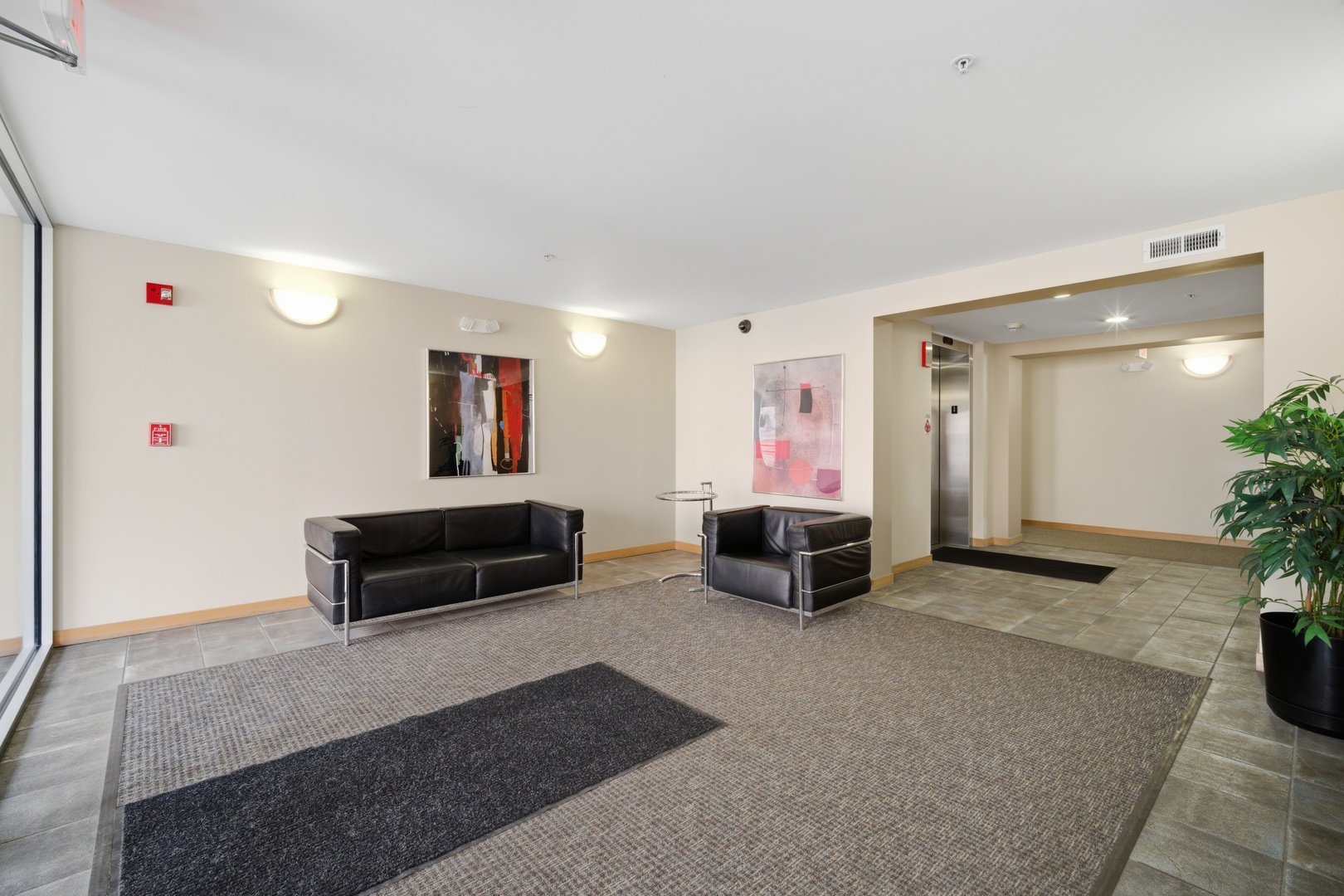 1625 Glenview Road, Unit 207 Glenview, IL 60025 - Photo 2 of 16 a living room with furniture and a flat screen tv
