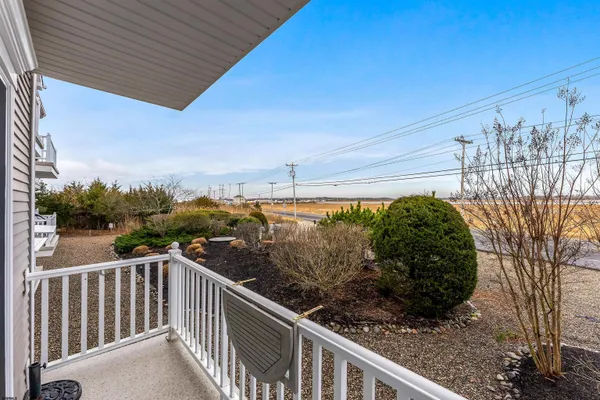 a view of a balcony with wooden fence