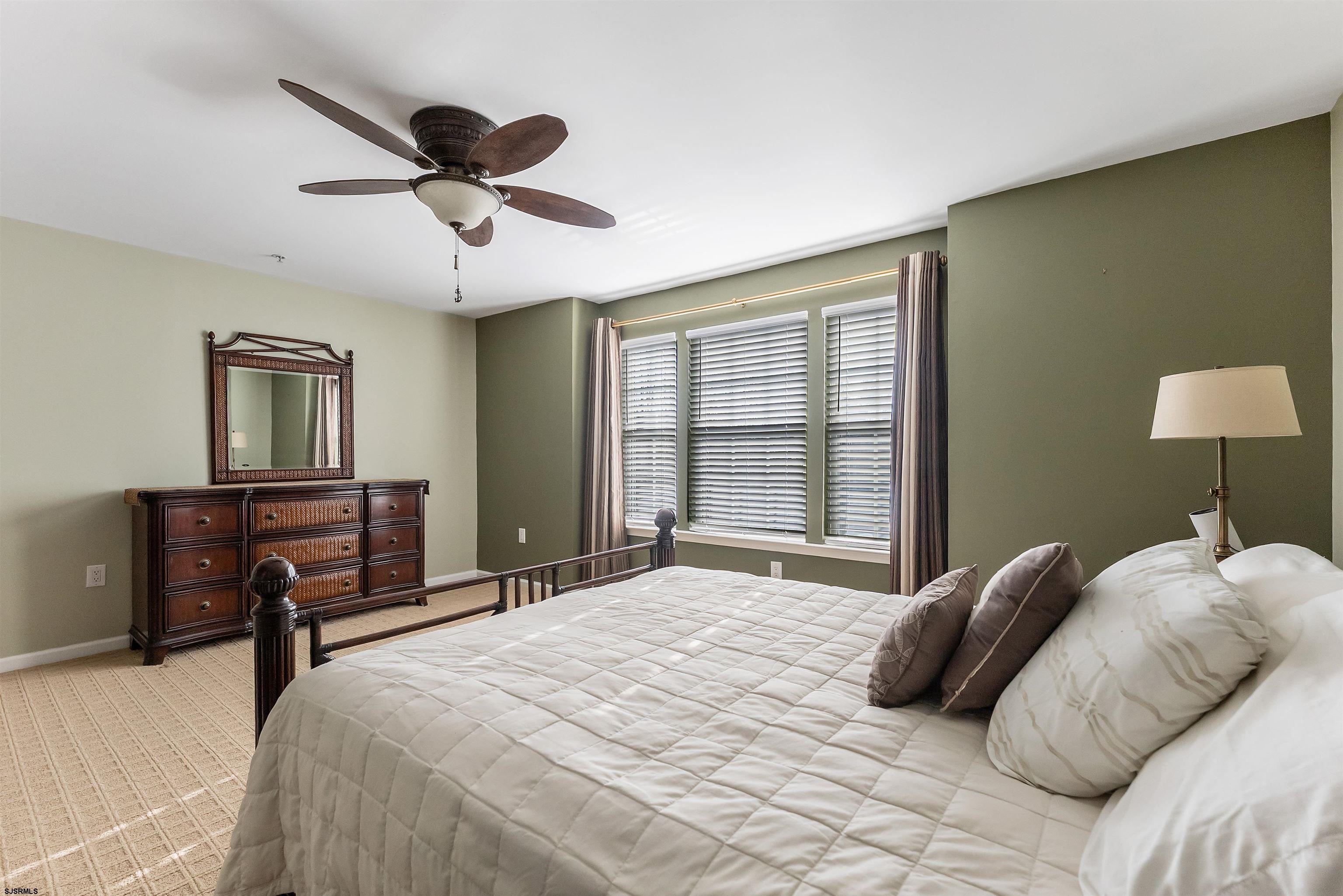 3 Bayside Drive, Unit 3 Somers Point, NJ 08244 - Photo 11 of 30 a bedroom with a bed and a chandelier