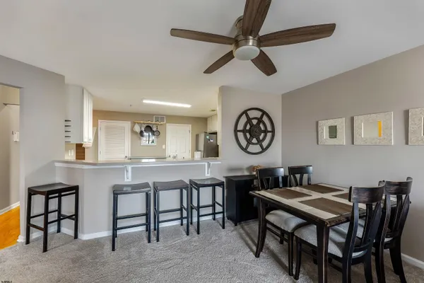 a view of a dining room that has a table and chairs in it