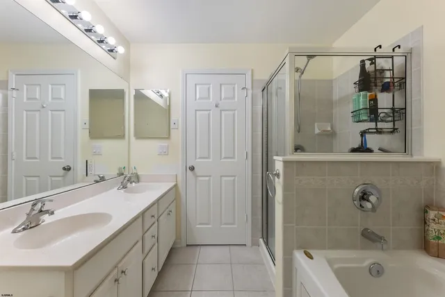 a bathroom with a tub sink and mirror
