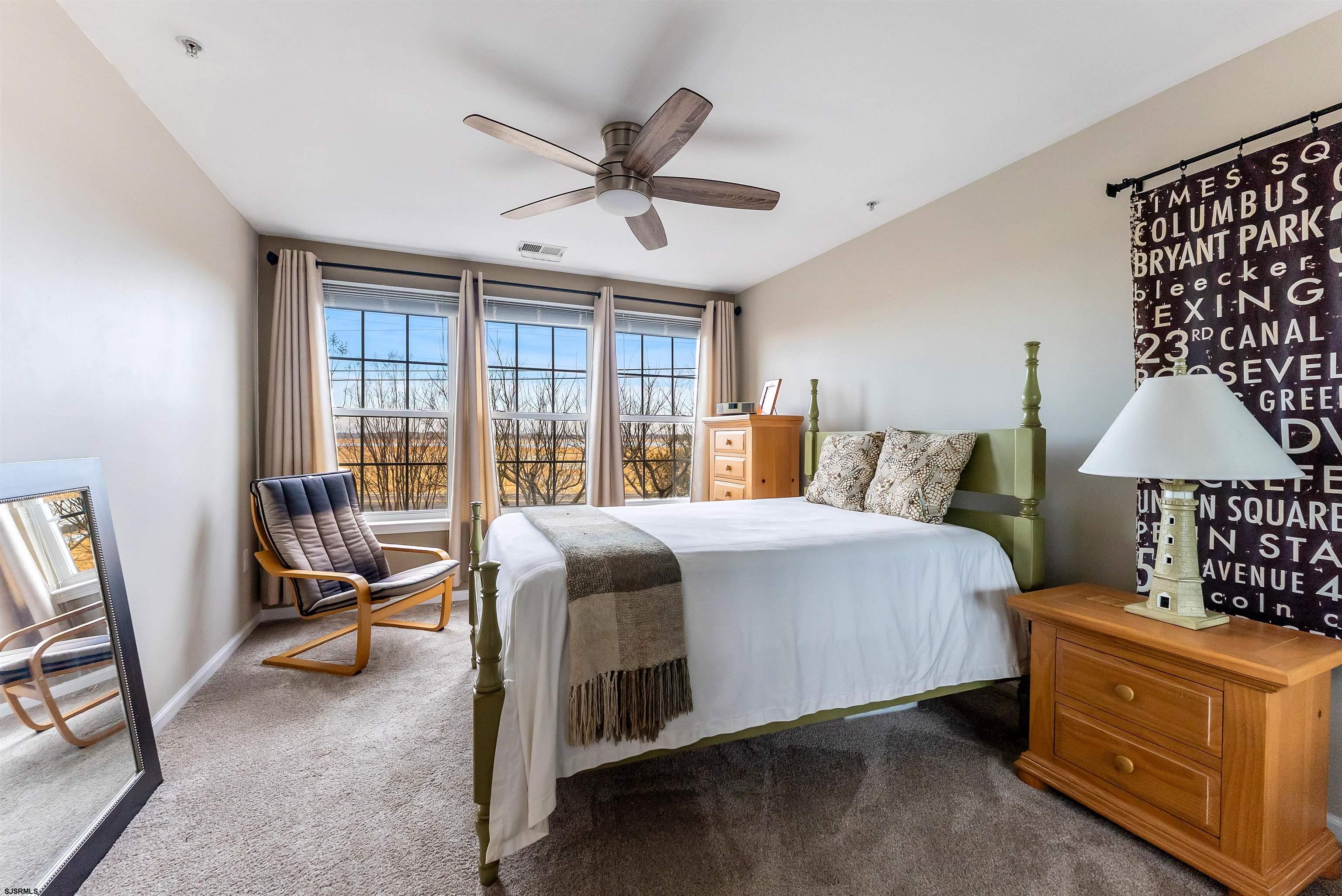 3 Bayside Drive, Unit 3 Somers Point, NJ 08244 - Photo 16 of 30 a bedroom with a bed and a chandelier