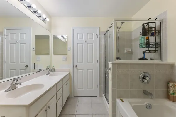 a bathroom with a tub sink and mirror