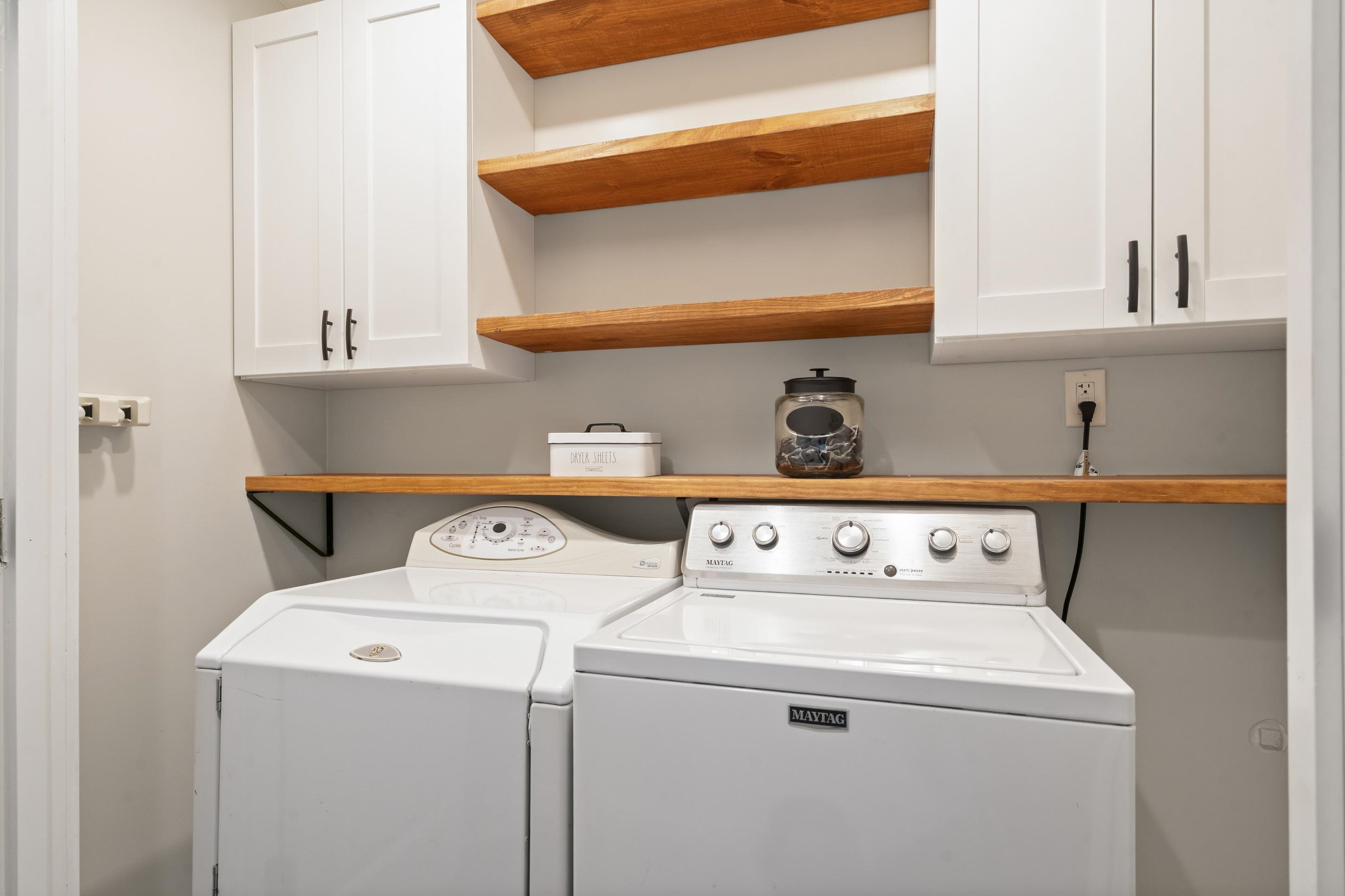 4370 Given Avenue Memphis, TN 38122 - Photo 14 of 30 Dedicated laundry space featuring white cabinetry with black hardware, natural wood-finish shelving, and a natural wood-finish countertop