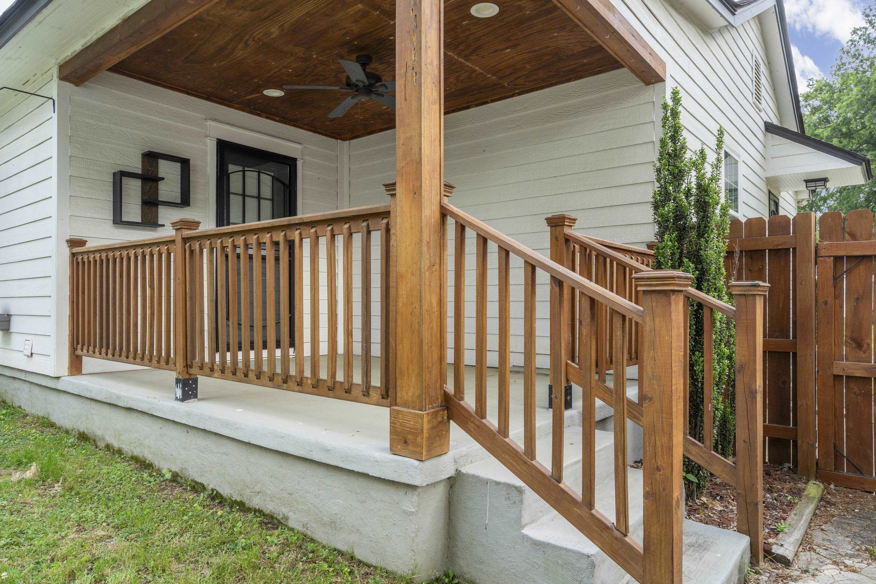 4370 Given Avenue Memphis, TN 38122 - Photo 16 of 30 Inviting front porch featuring a wood-finish ceiling with an integrated ceiling fan, white siding, and rich wood-tone railings and posts