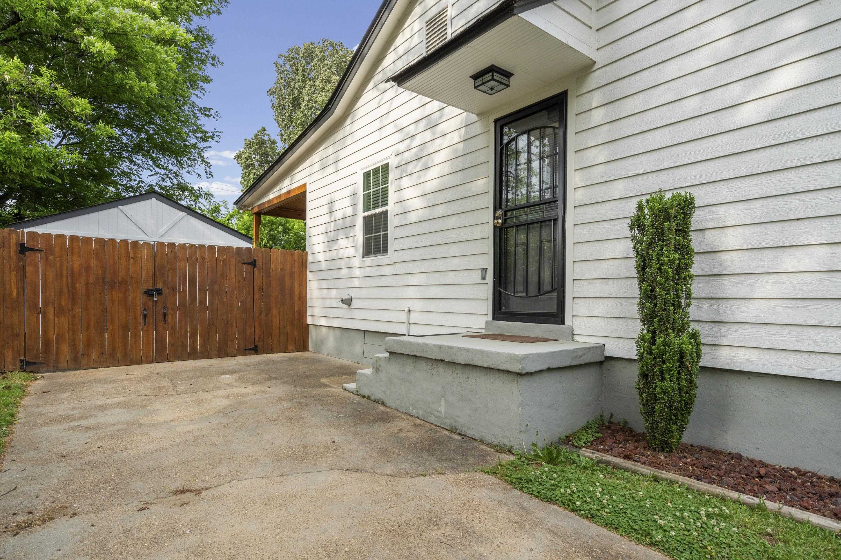 4370 Given Avenue Memphis, TN 38122 - Photo 23 of 30 White horizontal siding exterior with a black security door and concrete steps