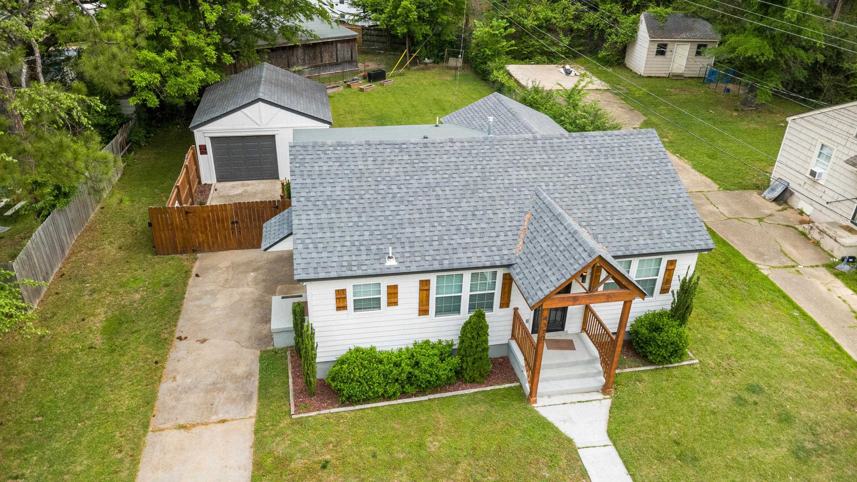 4370 Given Avenue Memphis, TN 38122 - Photo 24 of 30 White exterior with horizontal siding featuring a covered front porch with exposed timber framing