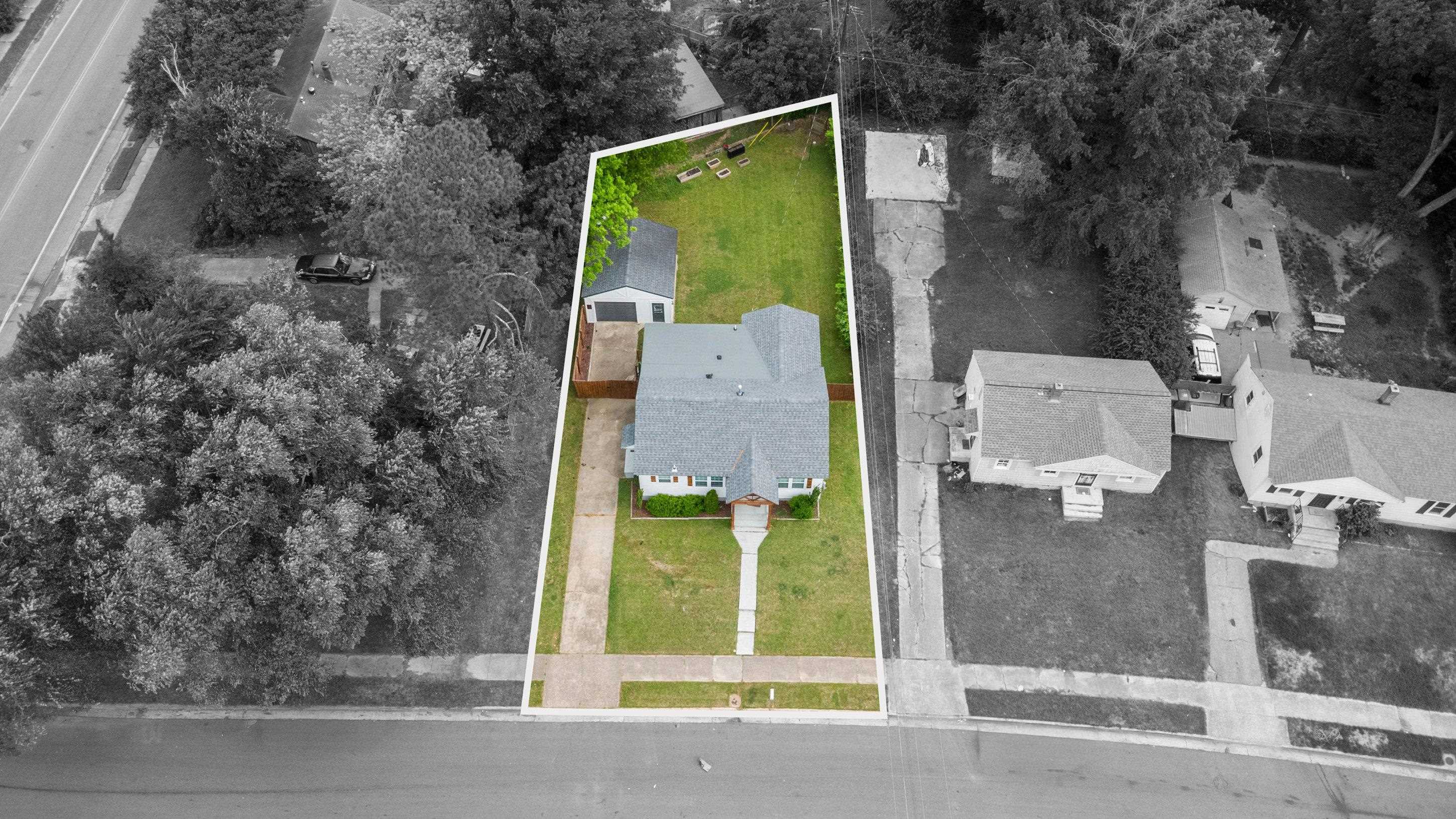 4370 Given Avenue Memphis, TN 38122 - Photo 27 of 30 Expansive property featuring a central residence with a detached outbuilding, a manicured lawn, and mature perimeter trees