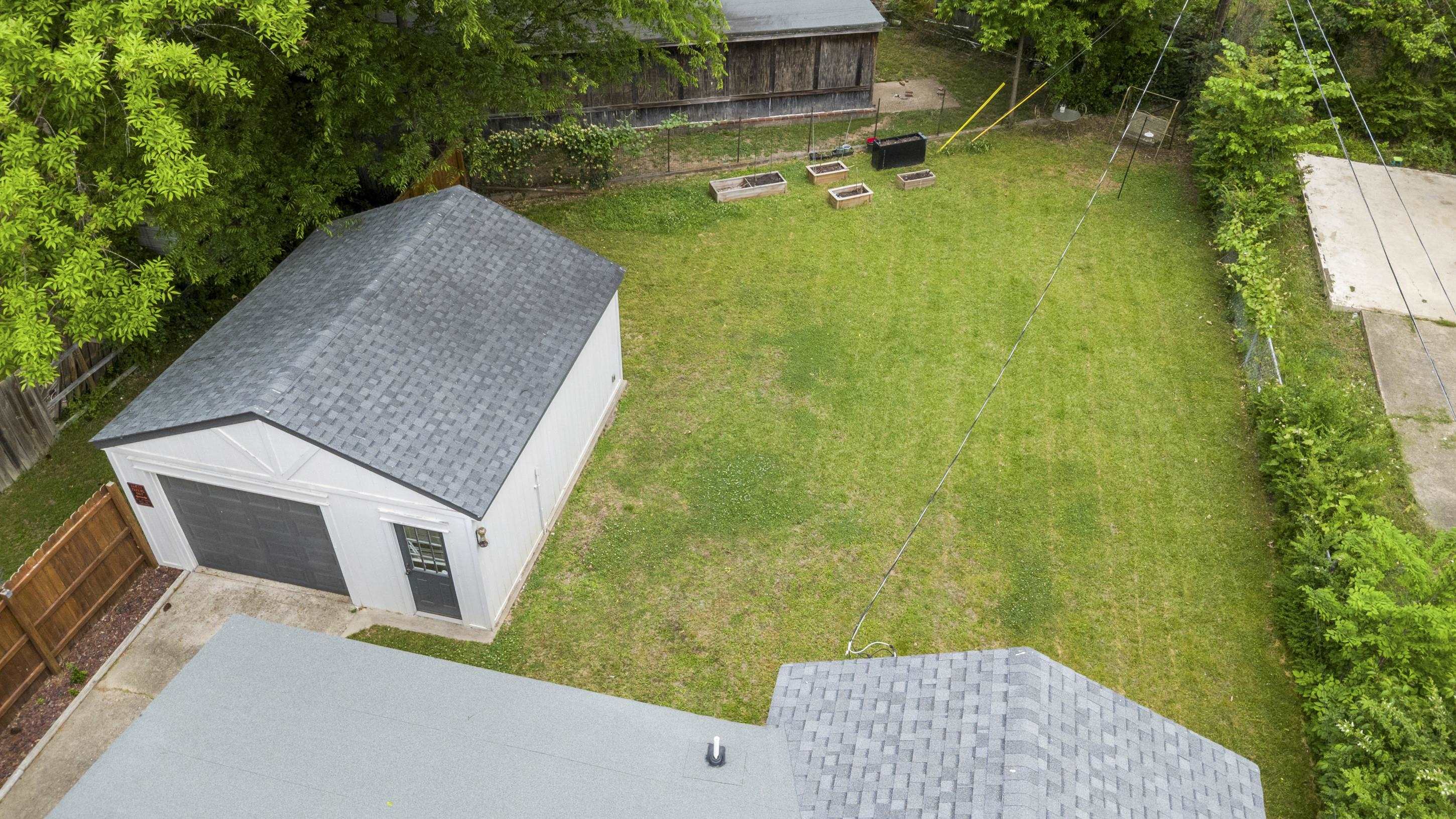 4370 Given Avenue Memphis, TN 38122 - Photo 28 of 30 Detached garage with a dark gray overhead door and side entry, set on a concrete pad