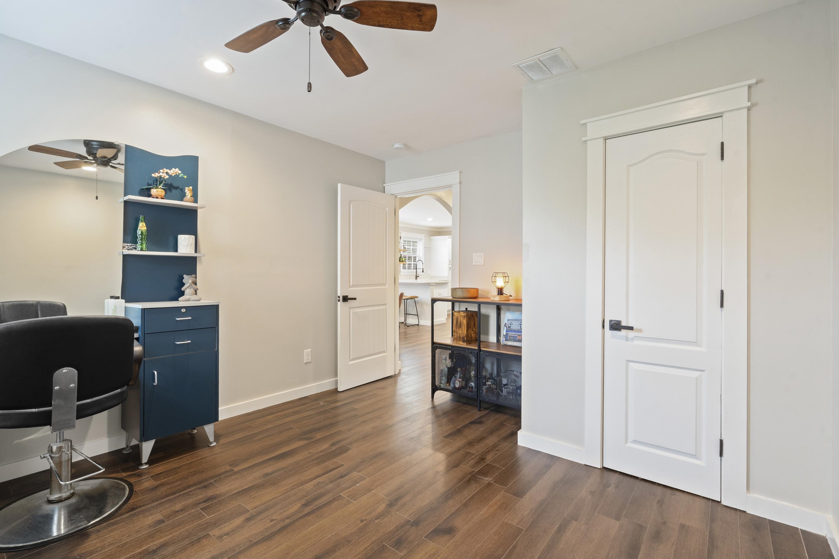 4370 Given Avenue Memphis, TN 38122 - Photo 9 of 30 Interior room featuring wood-finish flooring, a ceiling fan with integrated lighting, and multiple panel doors with dark hardware