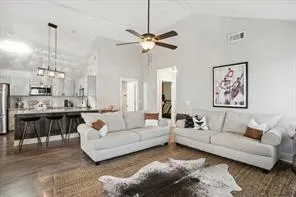 a living room with furniture and a chandelier