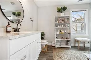 a bathroom with a toilet a sink and a mirror