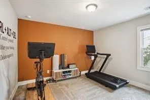 a room with gym equipment and a flat screen tv