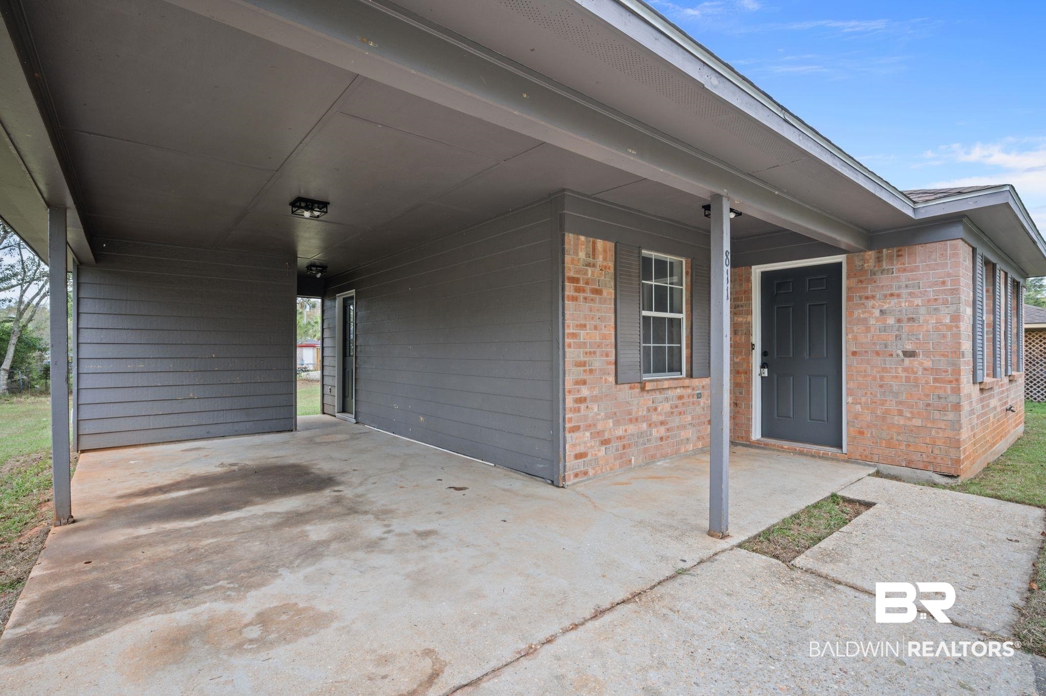 811 East Verbena Avenue Foley, AL 36535 - Photo 9 of 16 View of patio / terrace with a carport