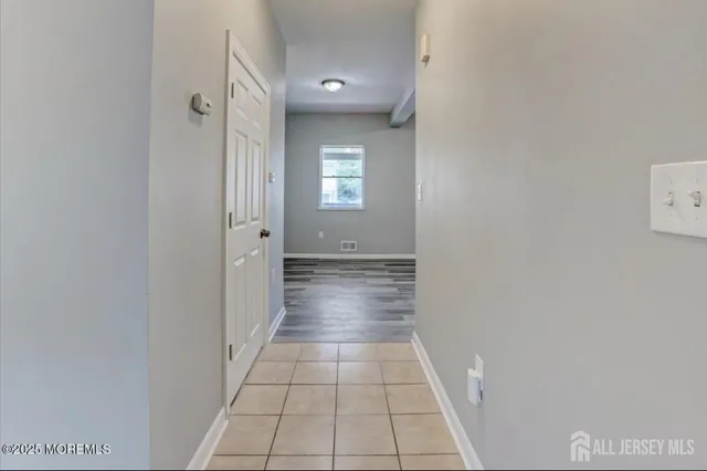 a view of a hallway with wooden shelves