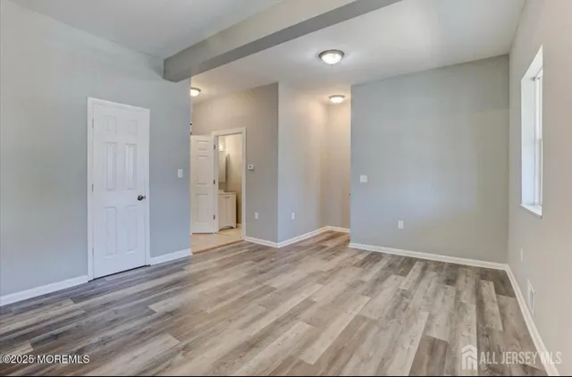 a view of an empty room and wooden floor