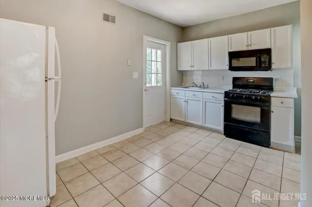 a kitchen with a stove top oven and sink