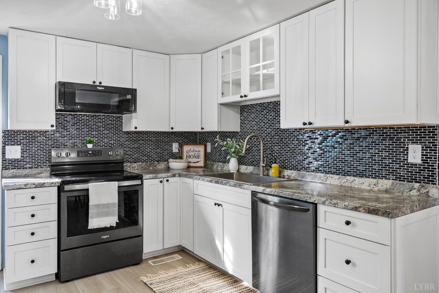 997 Toytown Road Amherst, VA 24521 - Photo 9 of 50 a kitchen with granite countertop white cabinets and stainless steel appliances