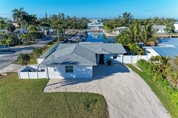 an aerial view of a house with swimming pool garden and patio