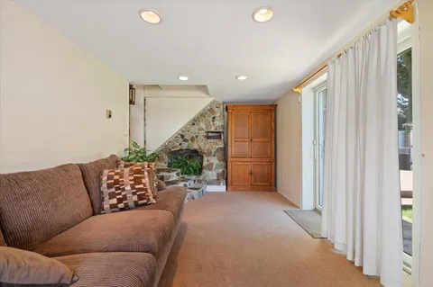 a living room with furniture and a ceiling fan