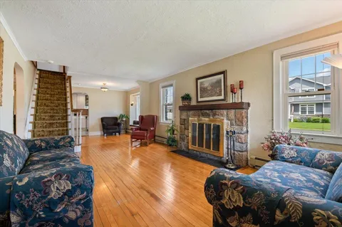 a living room with furniture a fireplace and a flat screen tv