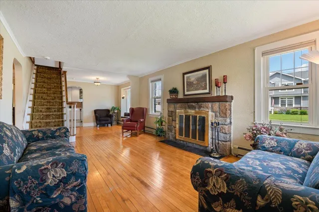 a living room with furniture a fireplace and a flat screen tv