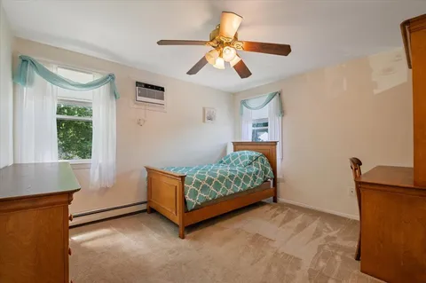 a bedroom with furniture and a window