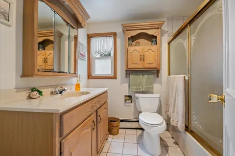 a bathroom with a toilet a sink and a mirror