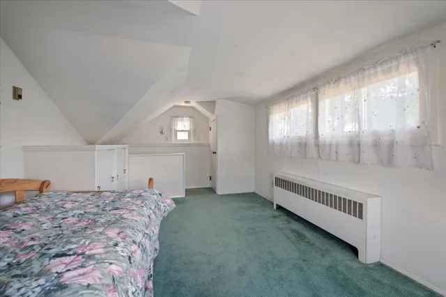 a spacious bedroom with a bed and a window