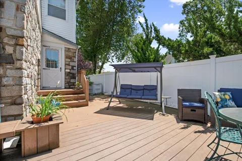 a view of a patio with a table and chairs and potted plants