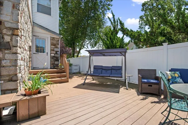 a view of a patio with a table and chairs and potted plants