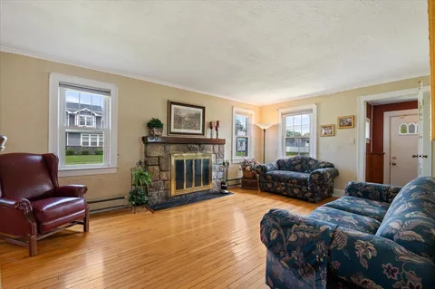 a bedroom with a bed wooden floor and window