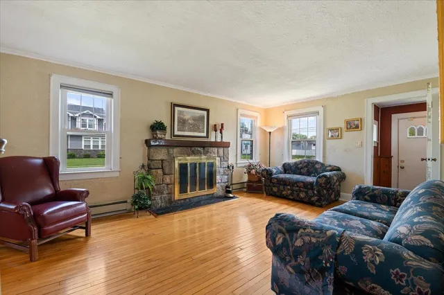 a bedroom with a bed wooden floor and window