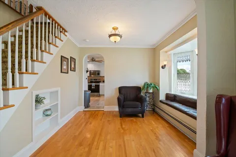 a living room with furniture and a wooden floor