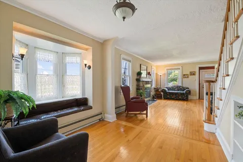 a living room with furniture gym equipment and a large window