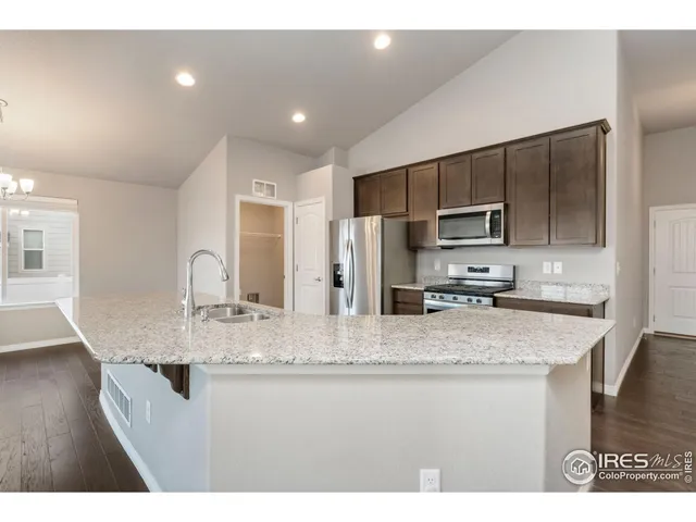 a bathroom with kitchen island granite countertop a sink and center island