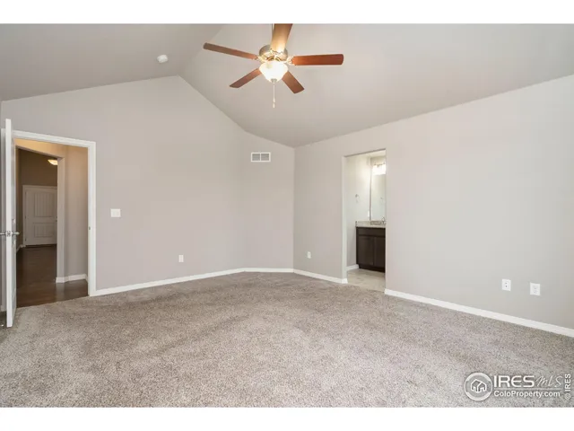 a view of an empty room with a ceiling fan