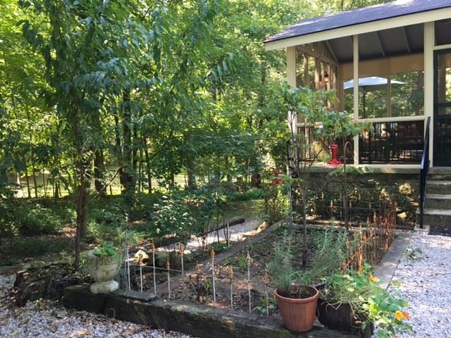 351 Greensview Road Sewanee, TN 37375 - Photo 3 of 13 a backyard of a house with outdoor seating and plants