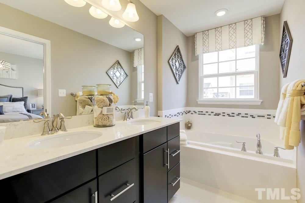 6605 Pathfinder Way Raleigh, NC 27616 - Photo 3 of 3 a bathroom with a large tub sink and mirror