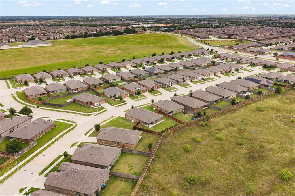 4600 Fringetree Way Crowley, TX 76036 - Photo 37 of 40 Expansive residential development featuring numerous single-story homes with brown shingle roofs