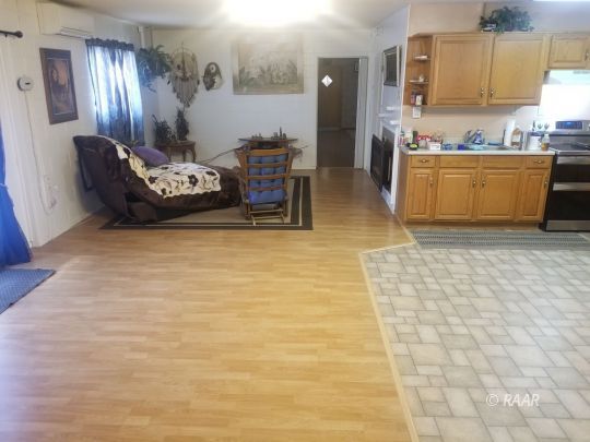 3735 West Ward Avenue Ridgecrest, CA 93555 - Photo 3 of 15 a living room with furniture and a kitchen area