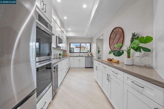 a kitchen with stainless steel appliances a refrigerator and microwave