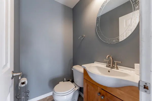 a bathroom with a sink mirror and toilet