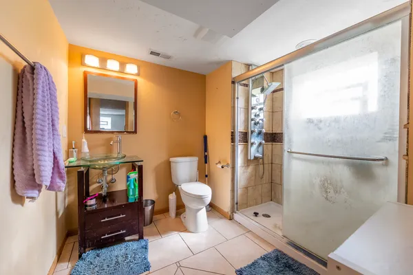 a bathroom with a toilet a sink and shower