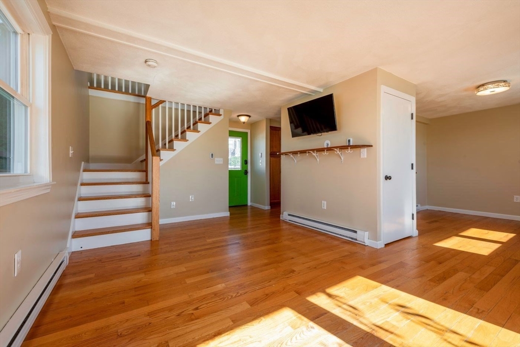 62 Eastern Point Road, Unit 3 Gloucester, MA 01930 - Photo 11 of 27 a view of a livingroom with wooden floor and stairs