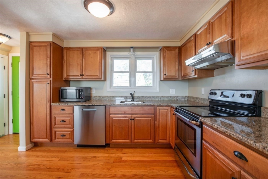 62 Eastern Point Road, Unit 3 Gloucester, MA 01930 - Photo 13 of 27 a kitchen with stainless steel appliances granite countertop a sink stove and refrigerator