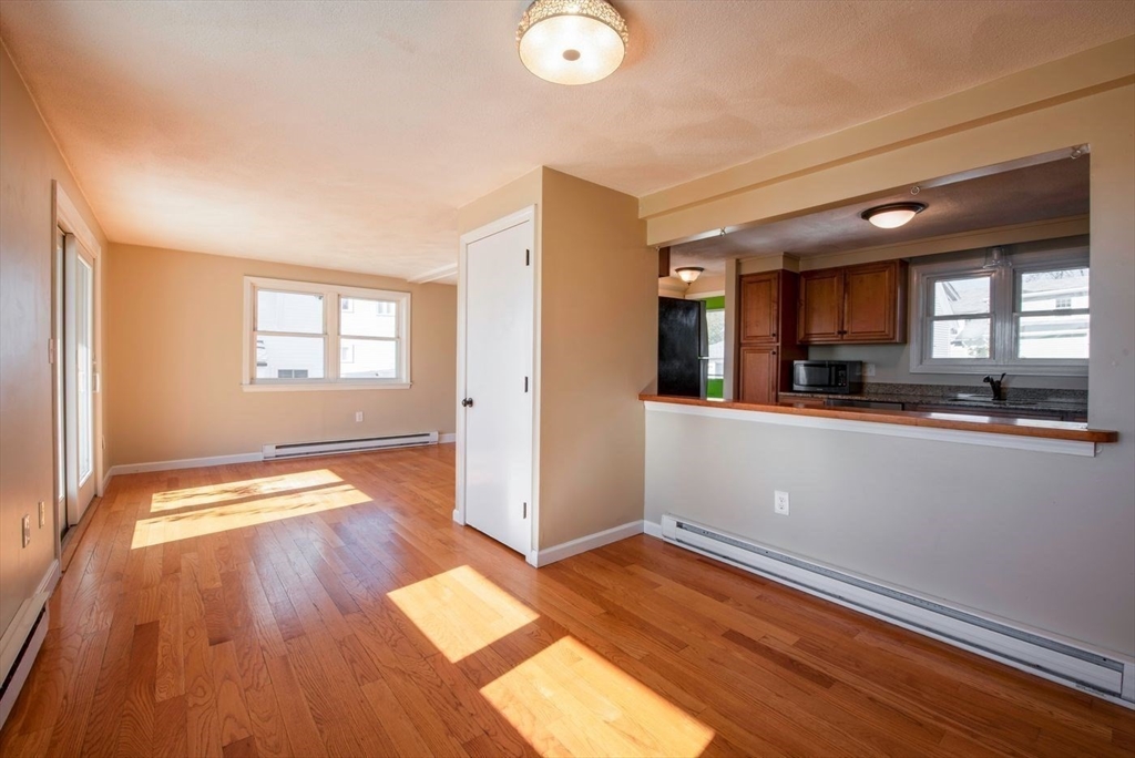 62 Eastern Point Road, Unit 3 Gloucester, MA 01930 - Photo 14 of 27 wooden floor in an empty room with a window