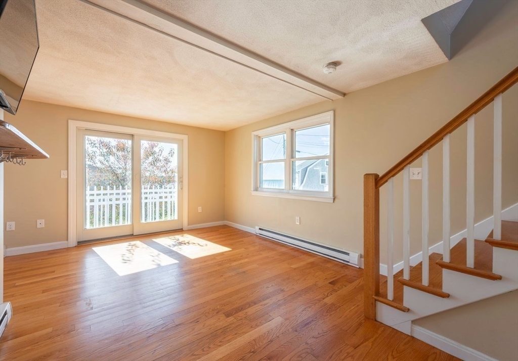 62 Eastern Point Road, Unit 3 Gloucester, MA 01930 - Photo 18 of 27 a view of an empty room with wooden floor and a window