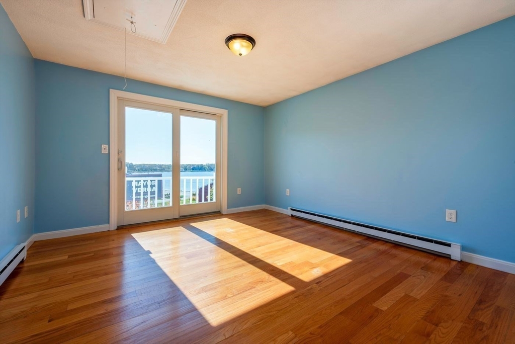 62 Eastern Point Road, Unit 3 Gloucester, MA 01930 - Photo 21 of 27 a view of empty room with wooden floor and fan